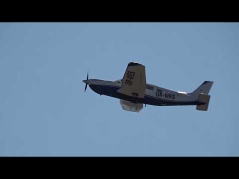 The Piper PA-32R-301T Saratoga II UR-WES plane arrived at Cherkasy airport. Walkway over the runway.