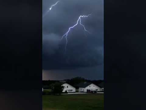 A tornado, lightning and thunder descend on a tall house