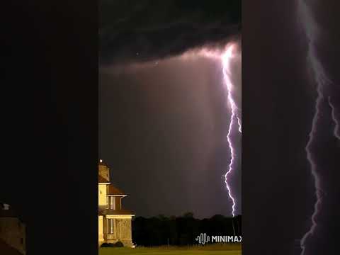 A tornado, lightning and thunder descend on a tall house