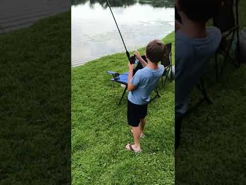 Zach reeling in a catfish.