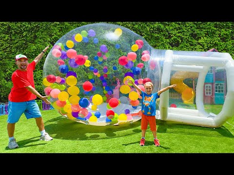 Chris plays with gumball machine and huge inflatable ball