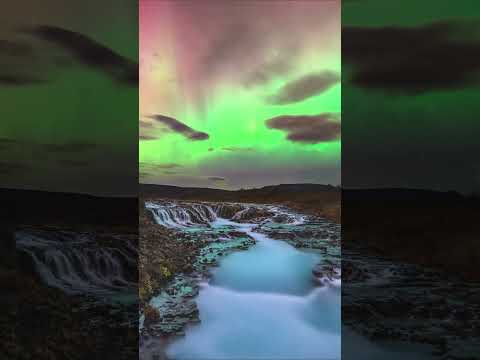 A geomagnetic storm illuminates Iceland's stunning Brúarfoss waterfall with green and red hues 💚