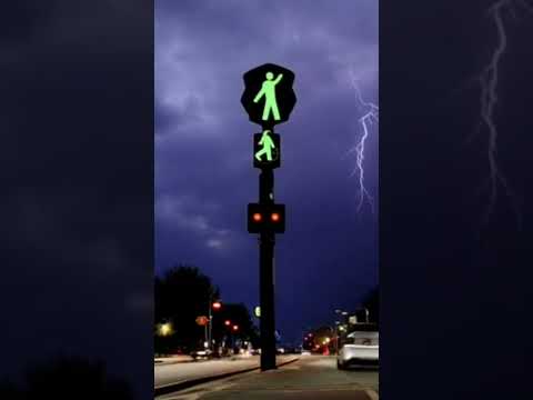 Lightning and thunder strike a car driving in the street