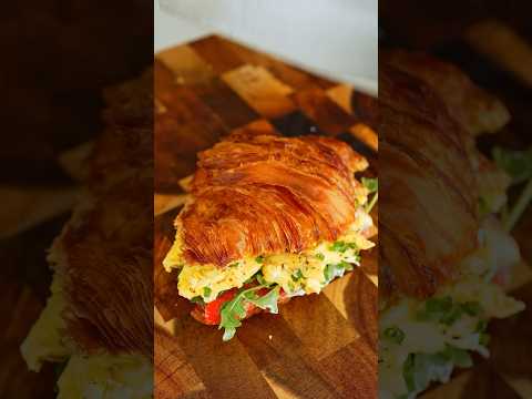 Scrambled egg croissant sandwich with cranberry wine spritzer