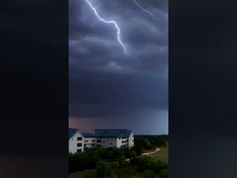 Lightning and thunder strike a car driving in the street